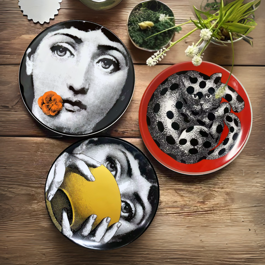 Three decorative ceramic plates with artistic designs on a wooden table.