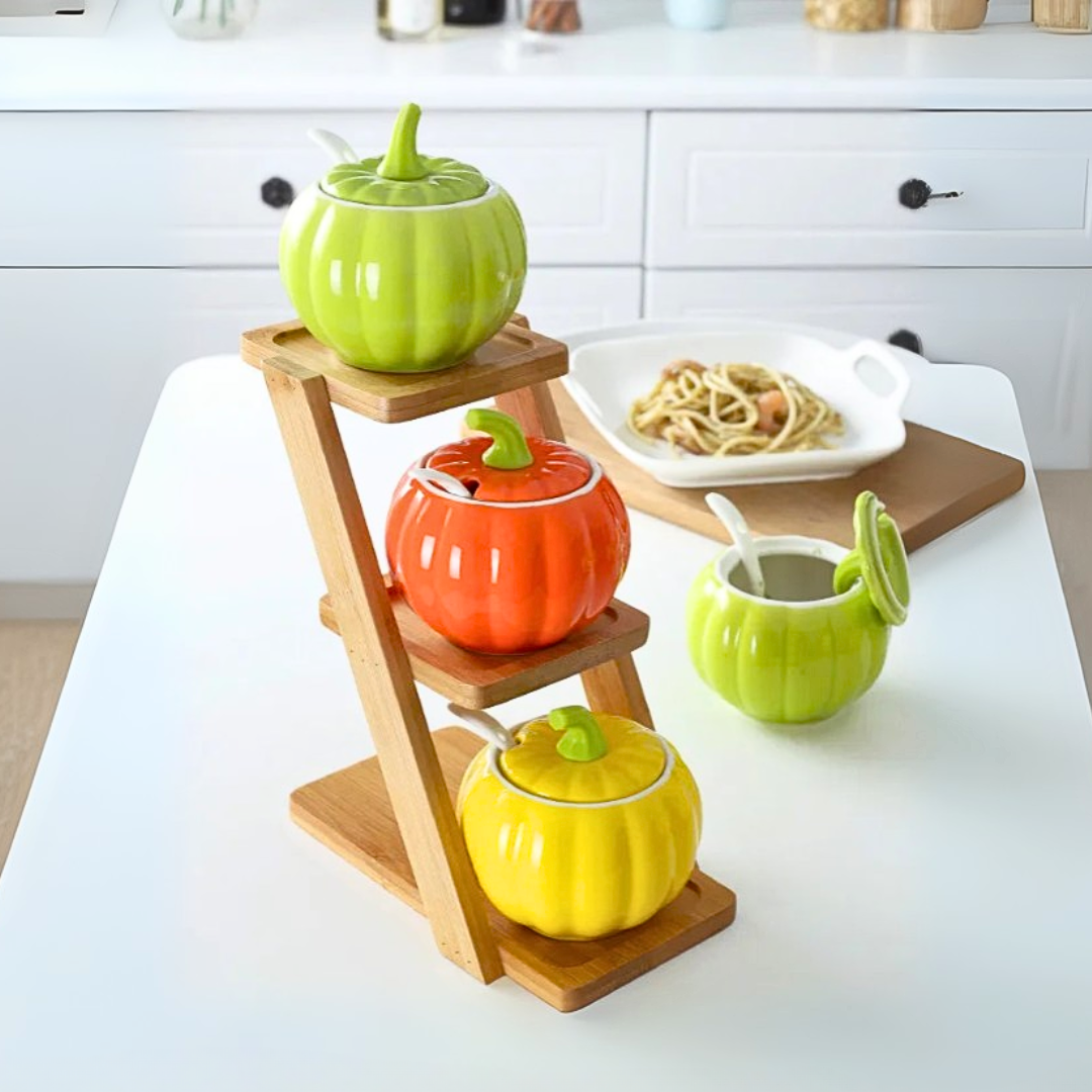 Colorful ceramic pumpkin-shaped containers on a wooden stand with a kitchen setting.