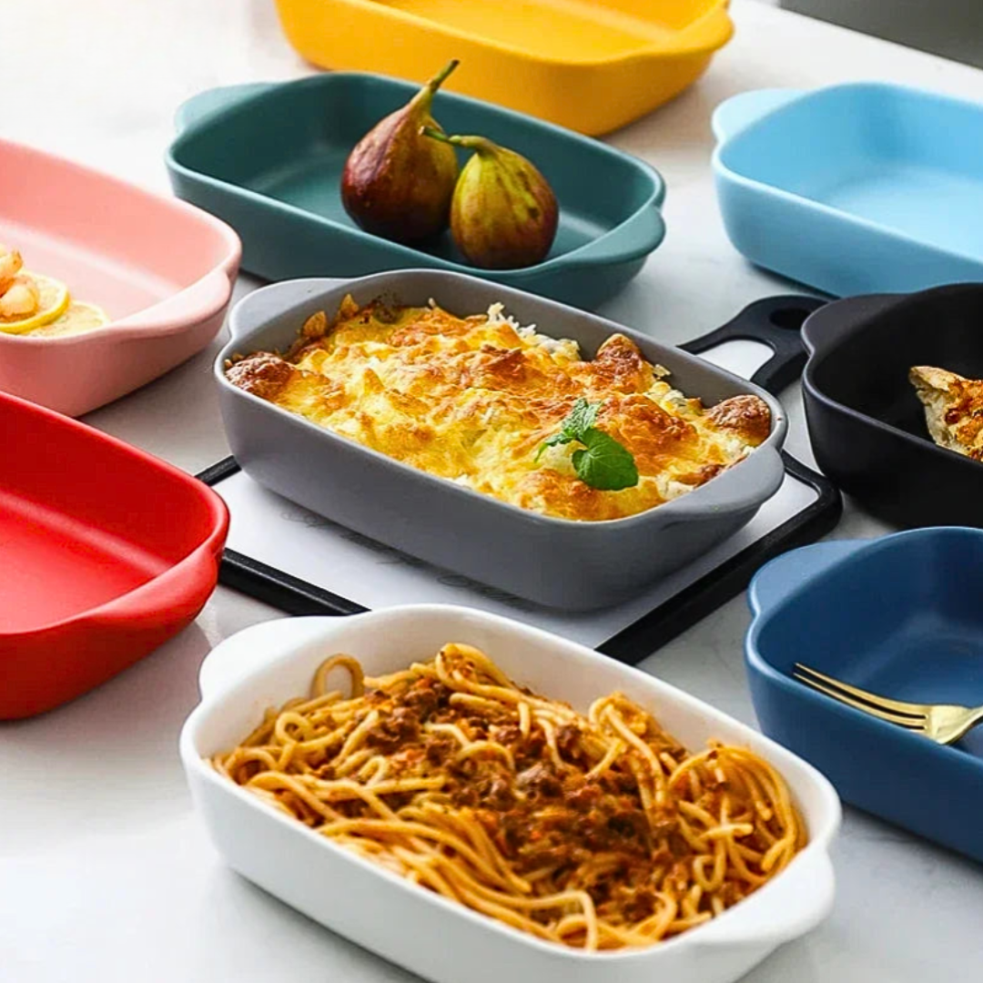 Colorful baking dishes with different types of food on a kitchen counter