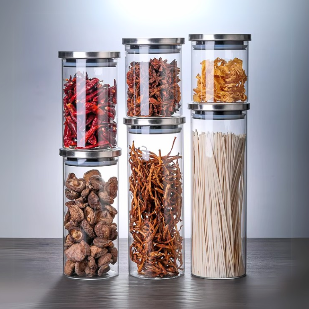 A set of glass food storage jars with airtight stainless steel lid with fried food.