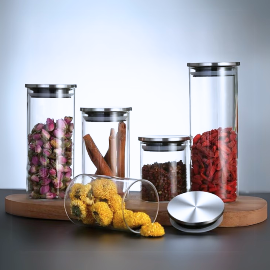 Set of glass food storage jars with airtight stainless steel lids on a wooden stand, containing various items.